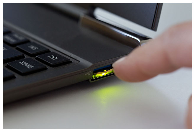 Photo of finger about to tap a security key